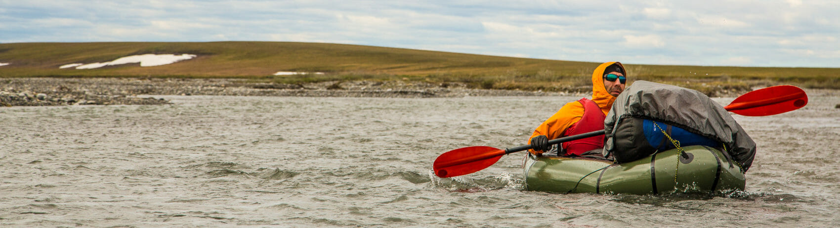 a packrafter navigates through the arctic refuge coastal plain