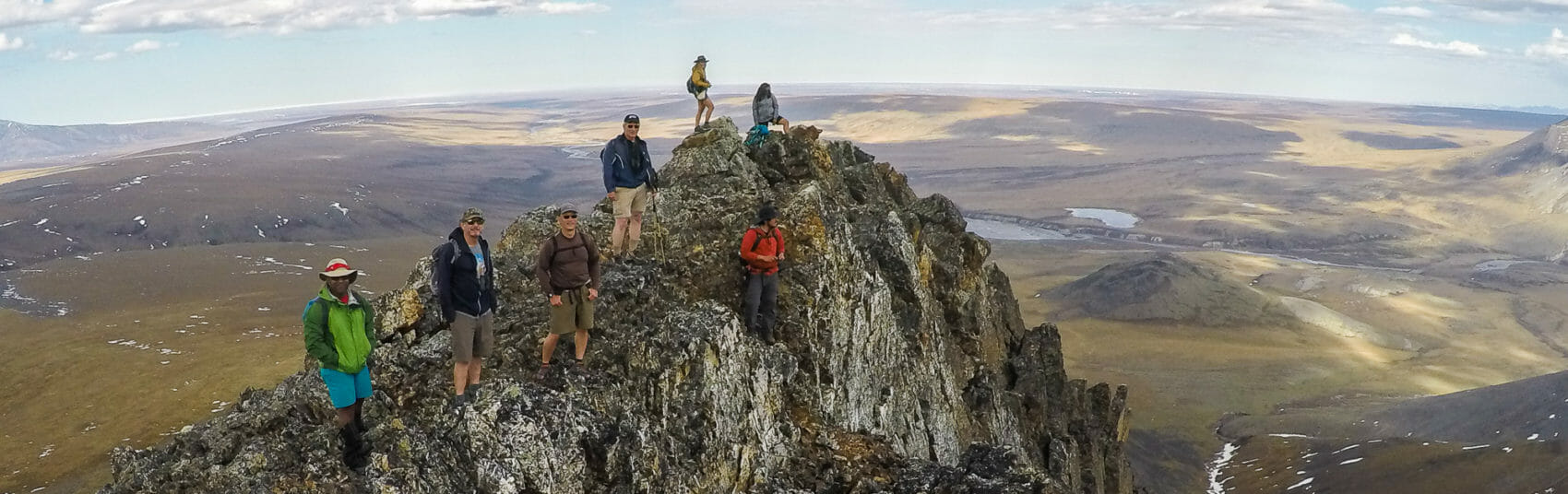 hikers ascend a peak in the northern brooks range