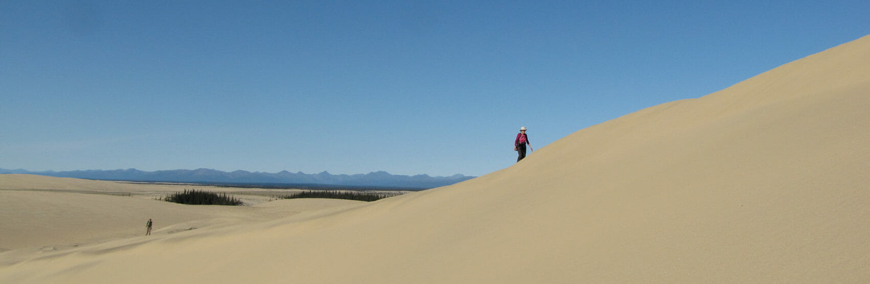 a hiker enjoys the kobuk sand dunes in kobuk valley national park